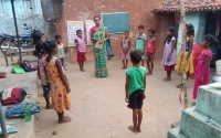 A Vidya Saathi teaches a small group of children at an outdoor Village Learning Center session in Berasisiram, Jharkhand