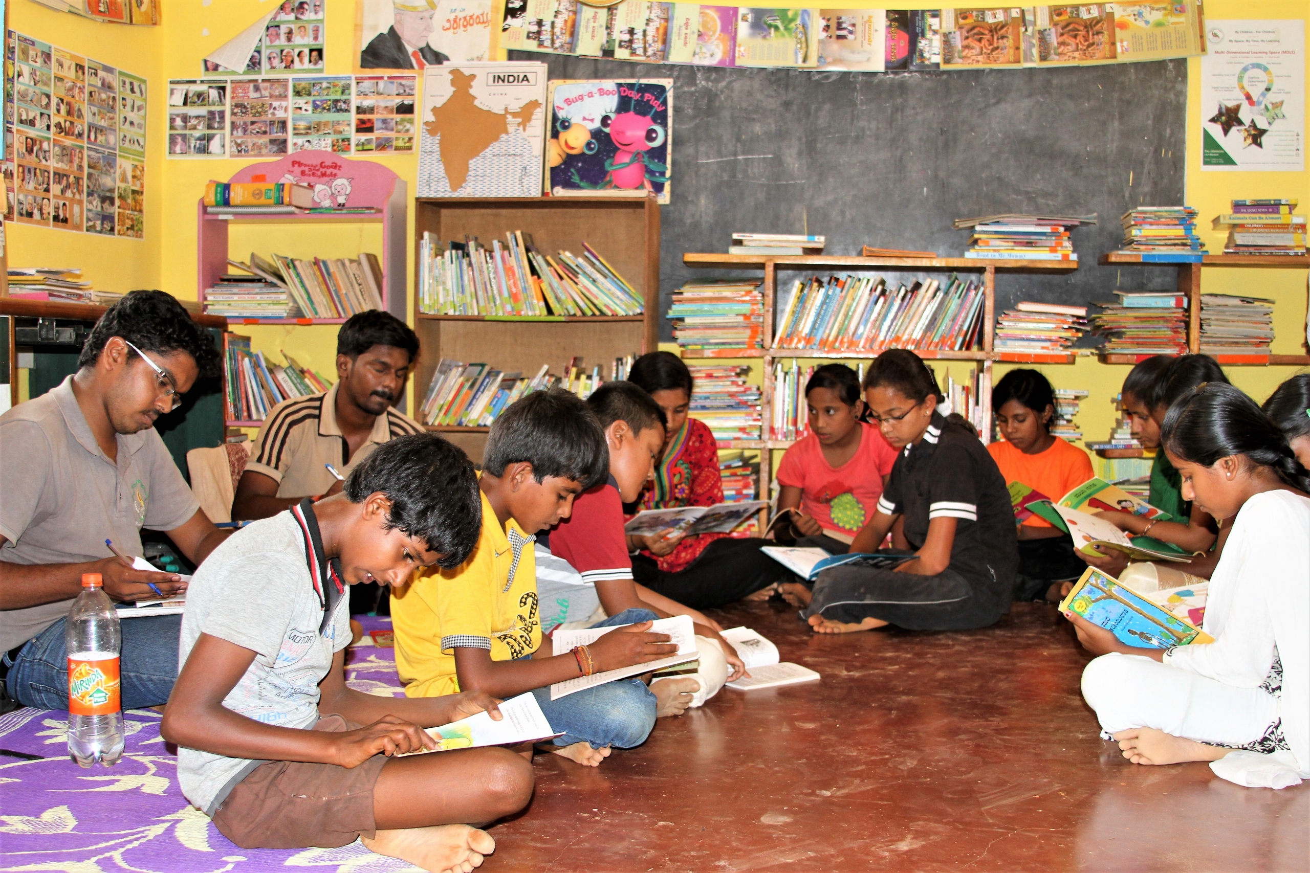 Students in a government school reading books during a library session