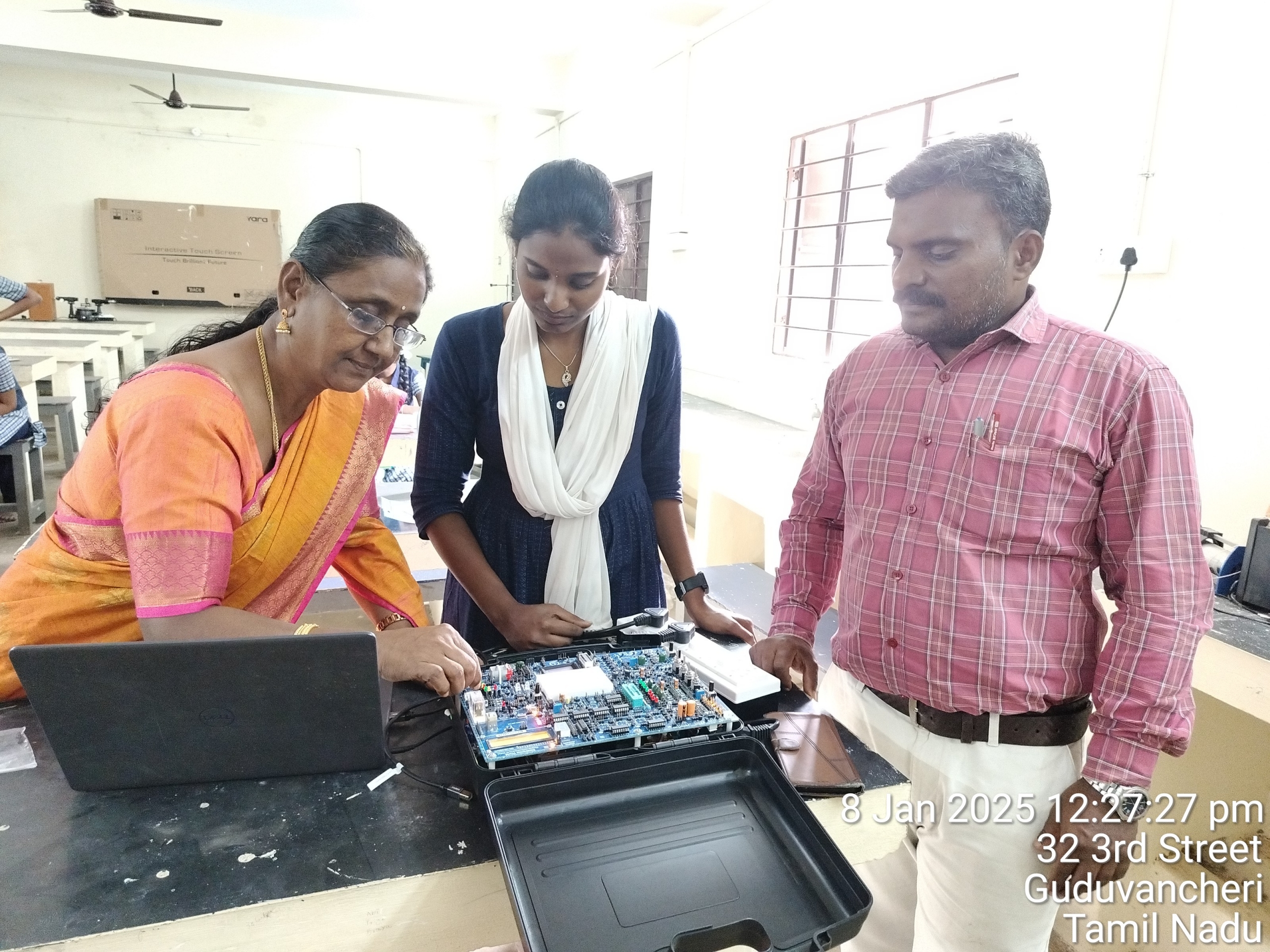 Teachers conducting electronics classes for students