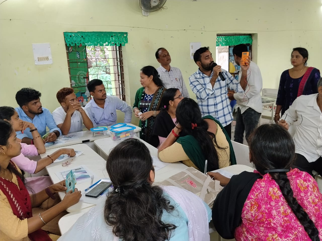 Teachers practicing experiments during a training session
