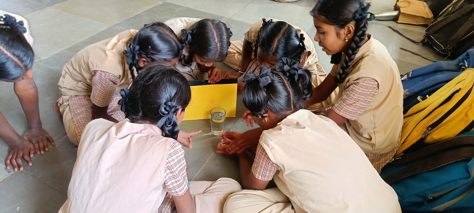 Students gathered around an experiment in class