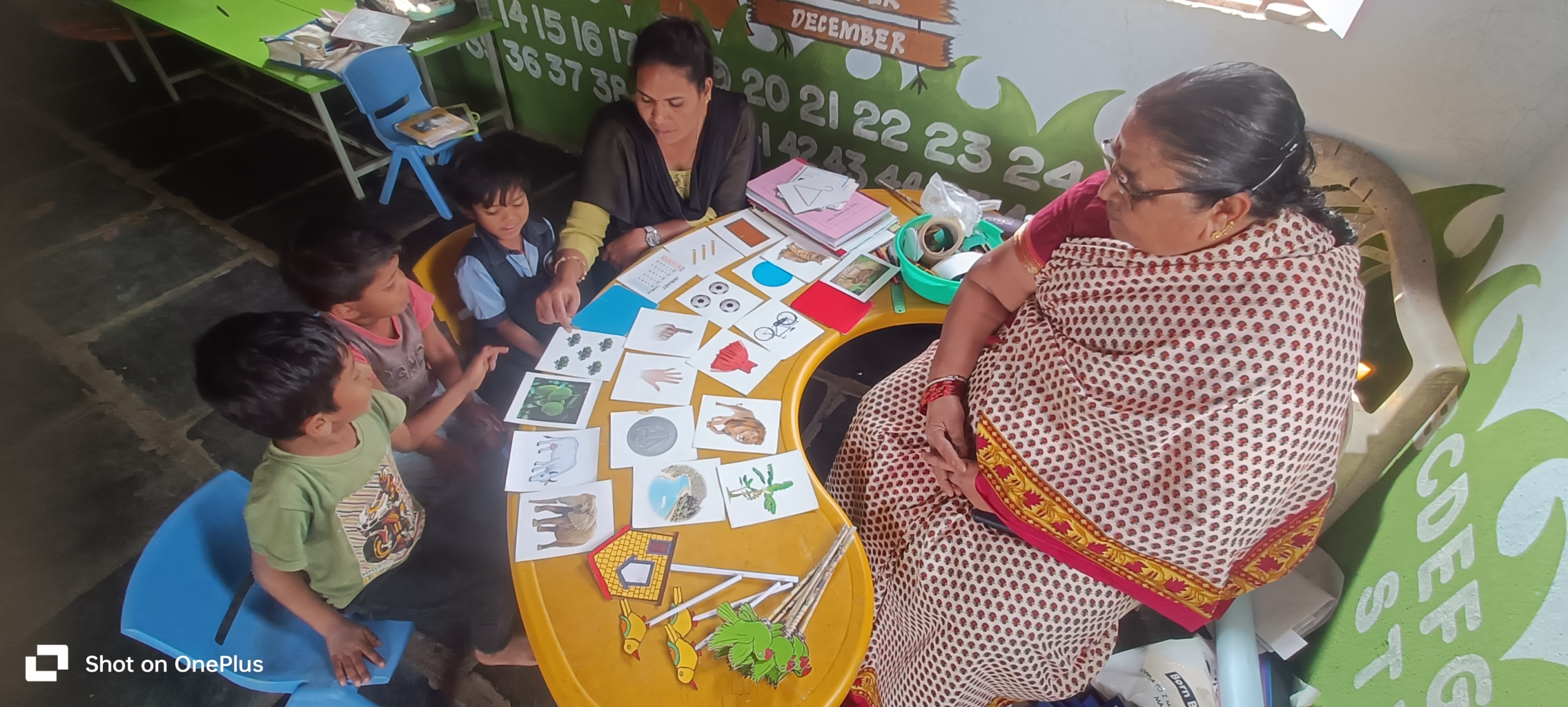 An Anganwadi worker with children during a learning session