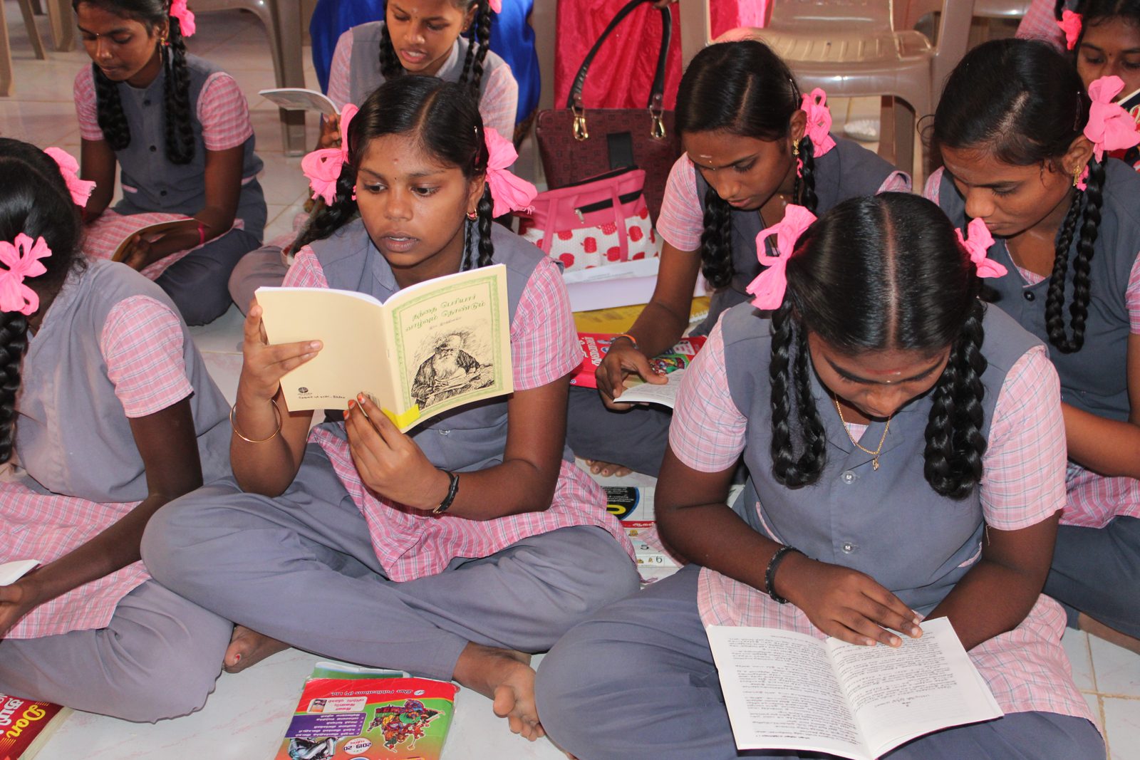 Students reading colour-coded library books during a reading period