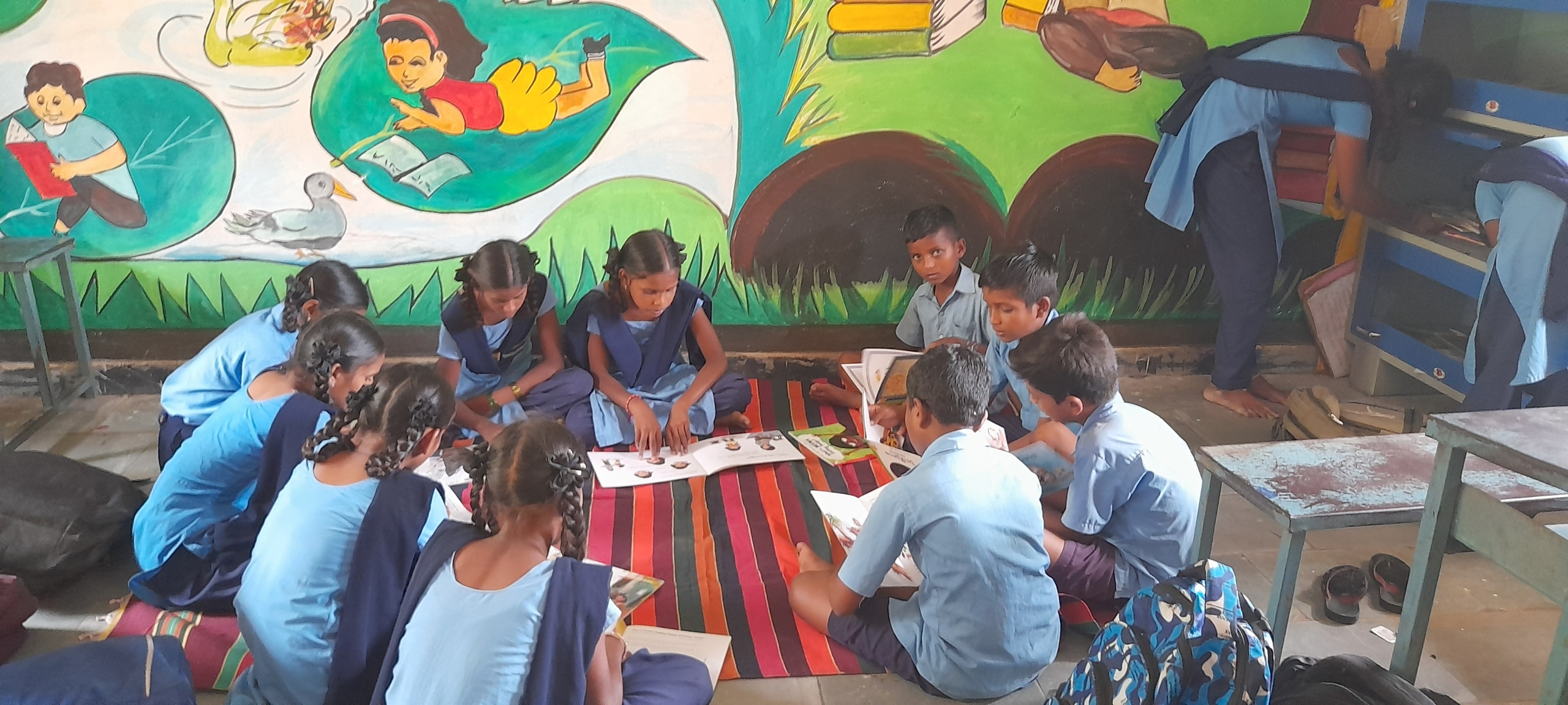 Students reading colour-coded books in a model school library