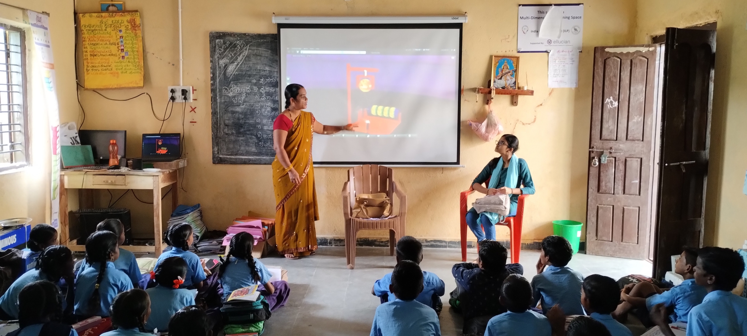 A teacher conducting class using digital content